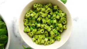 Delicious cheesy spinach pasta sauce served over pasta in a bowl.