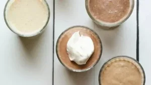 Homemade protein shake with fruits and protein powder in a blender.