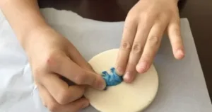 Children creating salt dough dinosaur fossils for a fun craft activity.