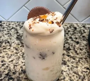Delicious Peanut Butter Cup Protein Milkshake topped with chocolate and peanut butter.