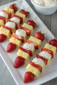 Strawberry shortcake kabobs with fresh strawberries and whipped cream on skewers