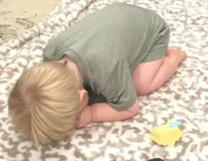 A parent guiding their toddler in discipline strategies and behavior correction.