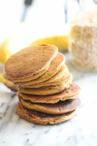 Plate of fluffy banana pancakes suitable for infants, made with applesauce.