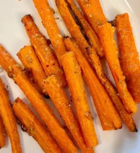 Garlic Parmesan Carrot Fries served in a bowl, garnished with herbs.