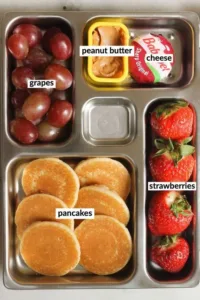 Variety of healthy lunch box ideas with colorful fruits and vegetables for kids and adults