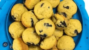Blueberry avocado mini muffins on a wooden board, perfect for breakfast.