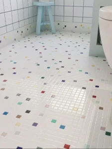 Colorful kids bathroom with playful tile floor and vibrant design elements.