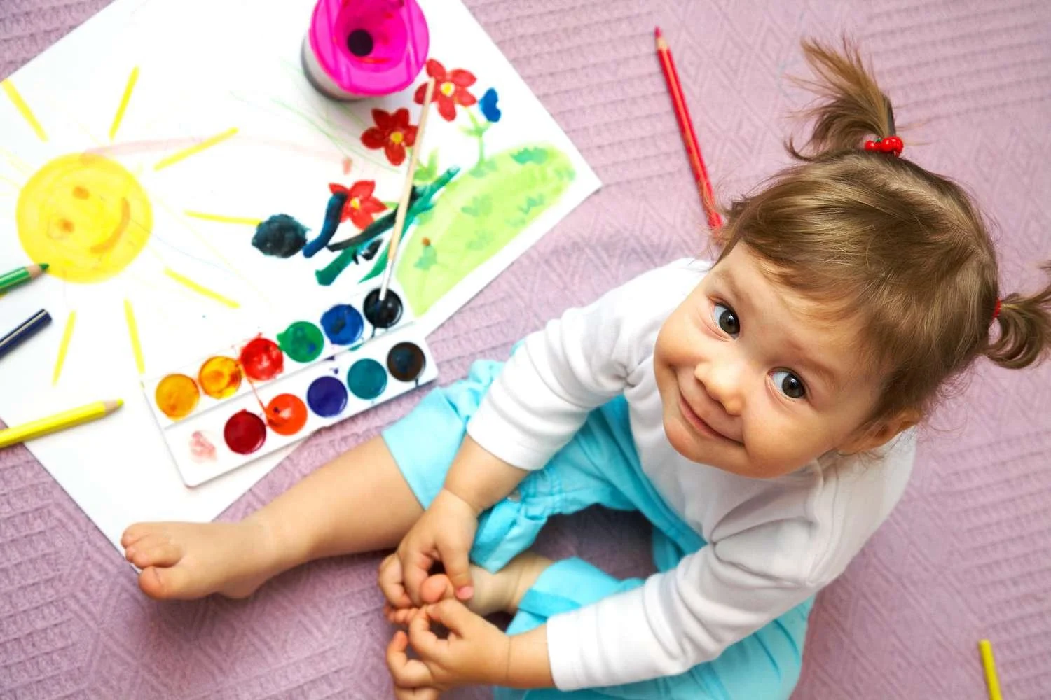 Toddler engaging in learning activities to grasp essential life lessons.