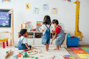 Toddler playing with colorful blocks in a screen-free activity environment.