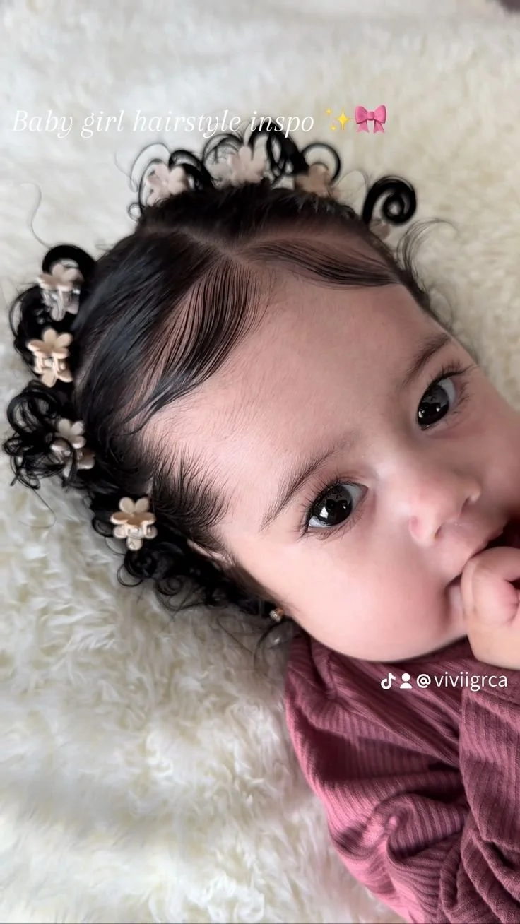 Baby girl wearing a beautiful flower crown hairstyle for a special occasion.