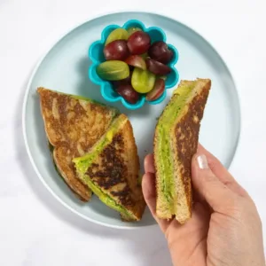 Delicious spinach grilled cheese sandwich served on a plate