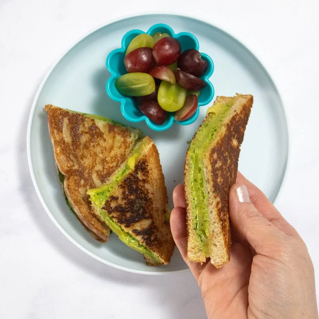 Delicious spinach grilled cheese sandwich served on a plate