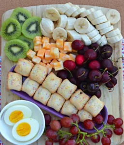 Colorful charcuterie breakfast board with kid-friendly snacks and fruits