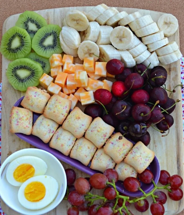 Colorful charcuterie breakfast board with kid-friendly snacks and fruits