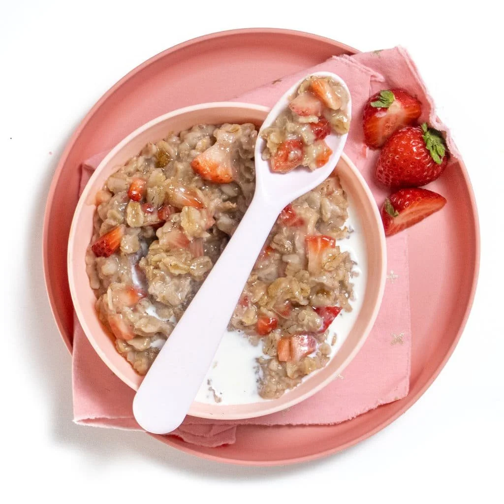 Healthy strawberry banana oatmeal bowl topped with fresh fruits and nuts