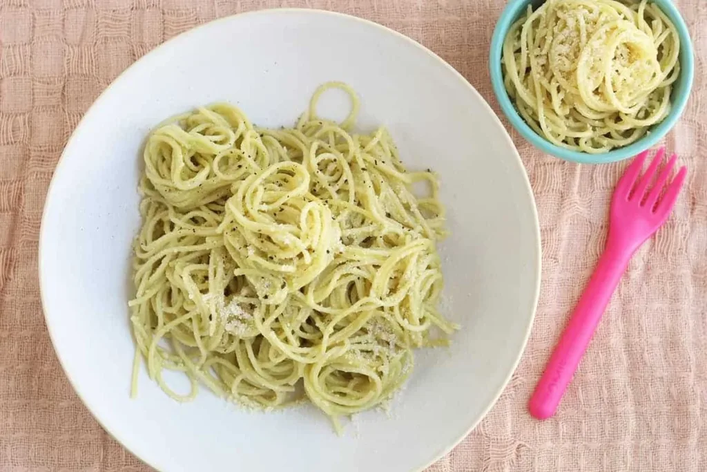 Delicious avocado pasta served in a bowl with fresh ingredients