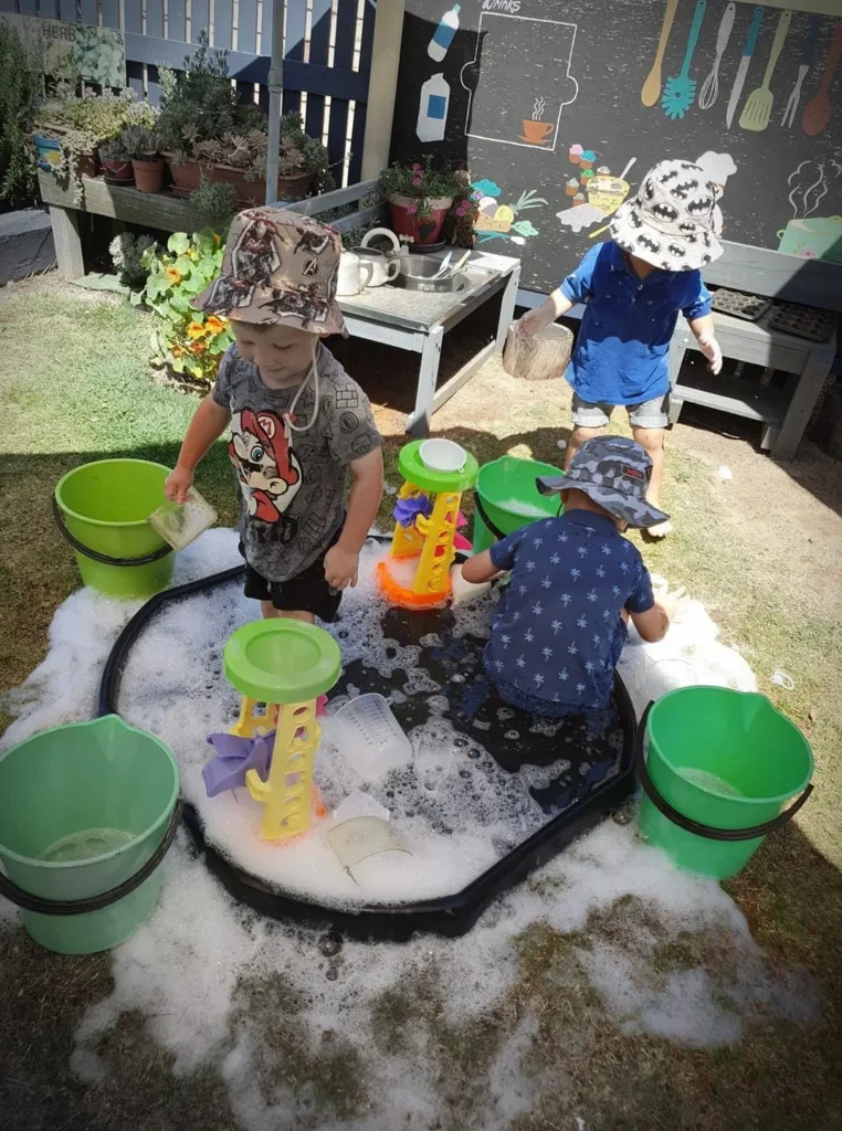 Toddler enjoying outdoor activities with nature at a park.
