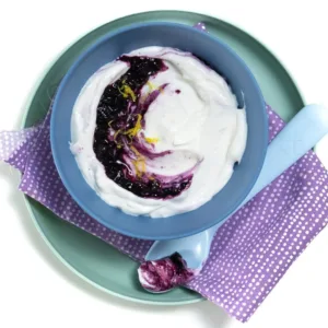 Delicious blueberry yogurt bowl topped with fresh berries and granola.
