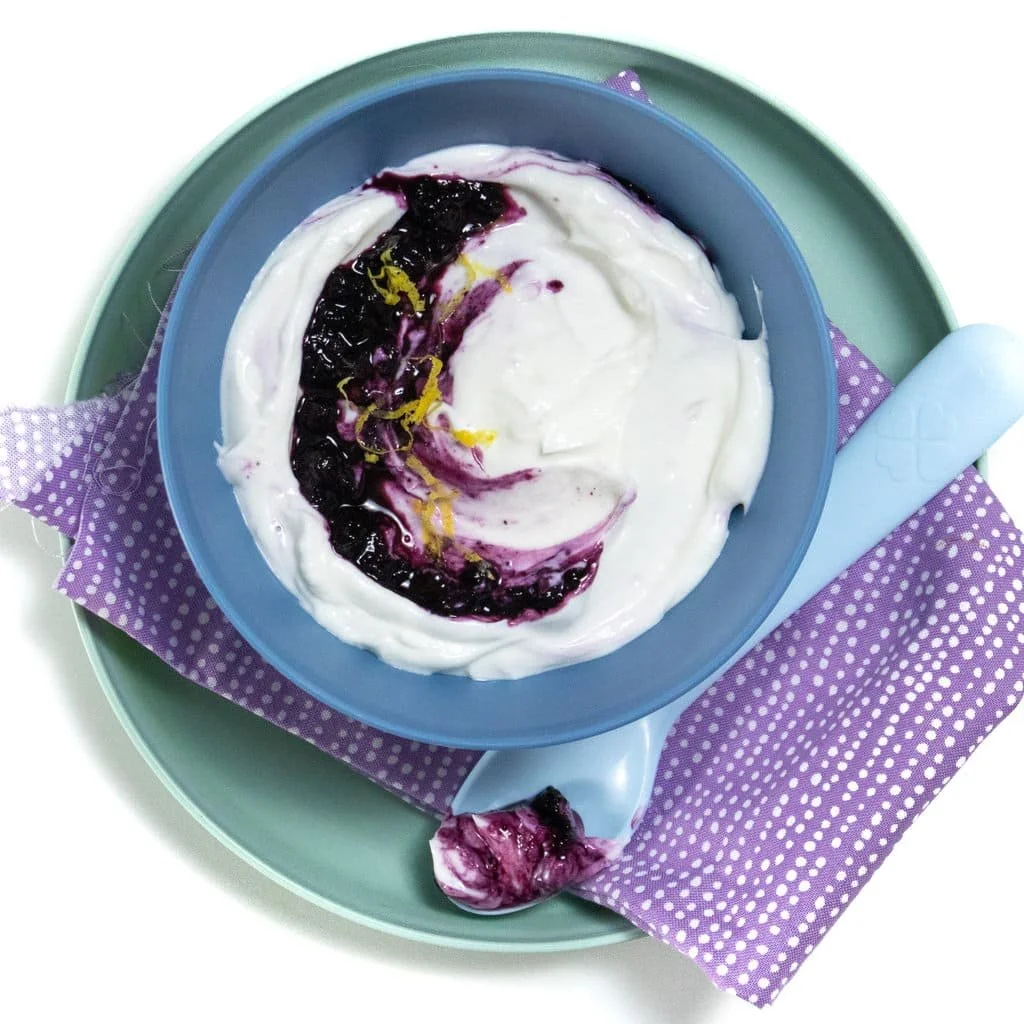 Delicious blueberry yogurt bowl topped with fresh berries and granola.